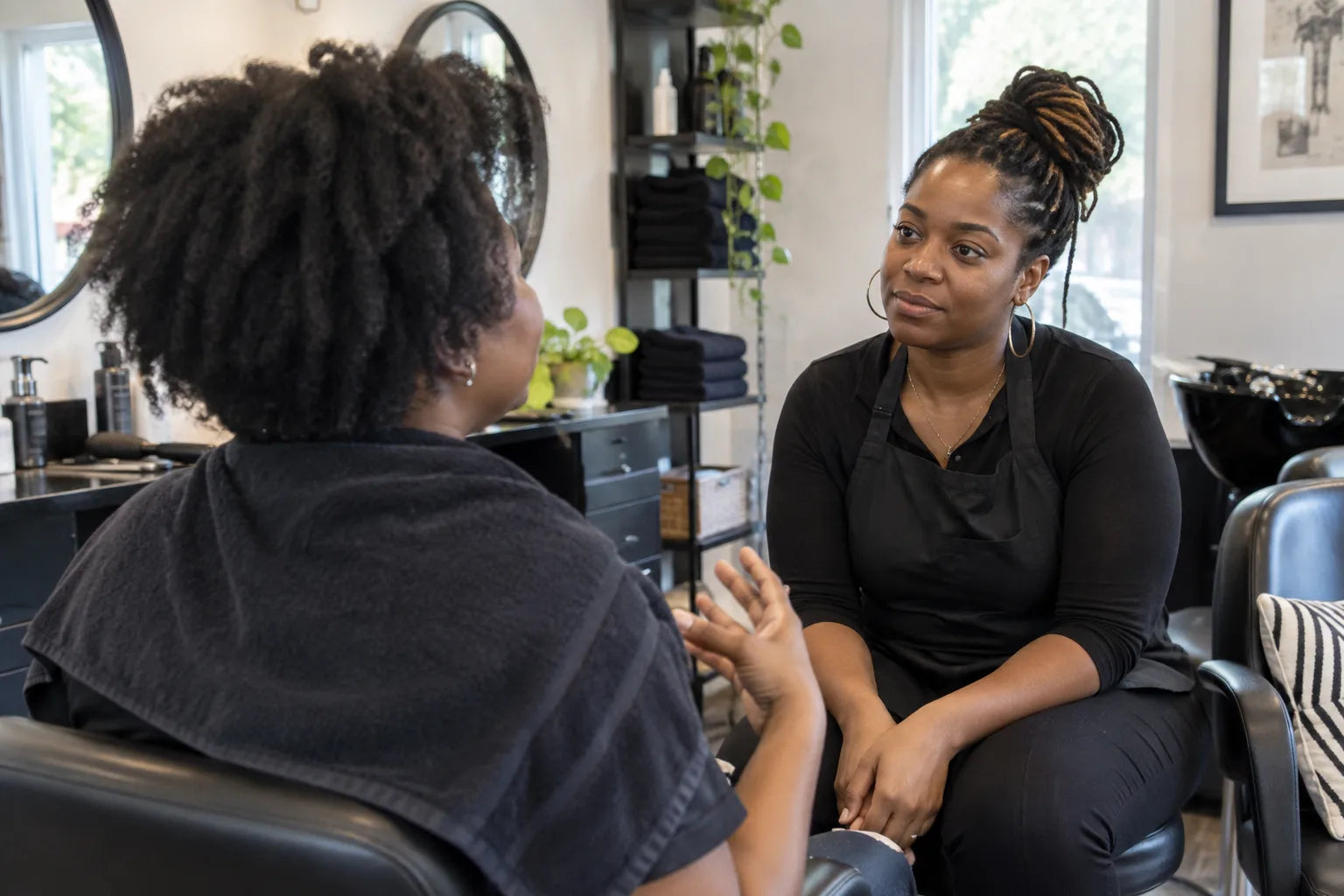 A client discussing natural hair care with her stylist